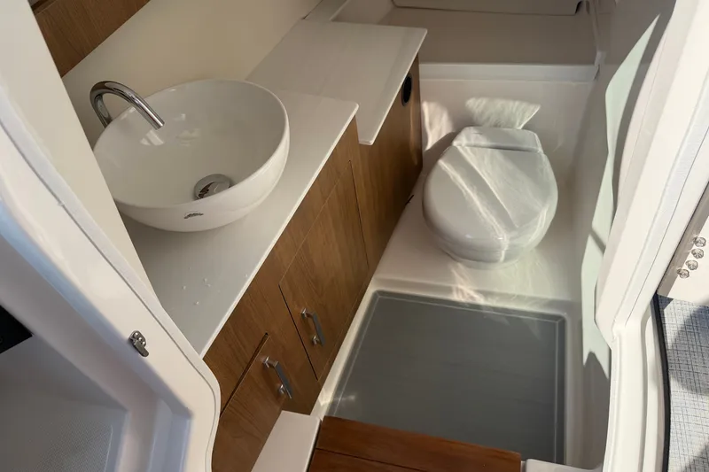Slide: The Image of Modern bathroom interior in 2027 Regal 3300 boat, featuring sleek sink and toilet. - 29