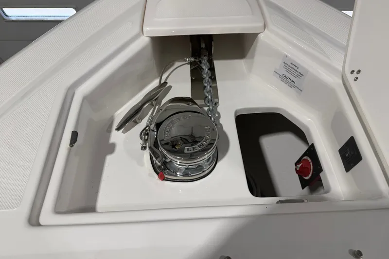 Slide: The Image of Anchor compartment of 2027 Regal 3300 boat with chain and control panel. - 14