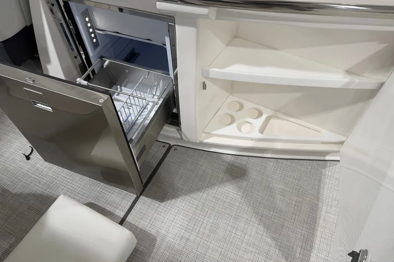 Slide: The Image of Modern kitchen area in a 2027 Regal 3300 boat with open fridge and storage. - 12