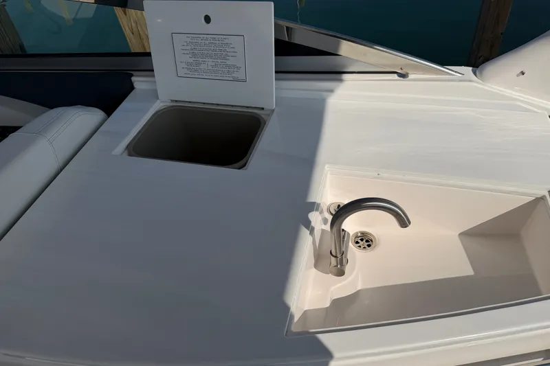 Slide: The Image of Regal 3300 (2027) boat sink and storage area in sunlight. - 22
