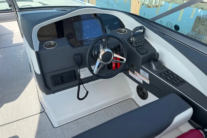 Slide: The Image of Cockpit of a 2027 Regal 3300 boat featuring modern controls and navigation system. - 8