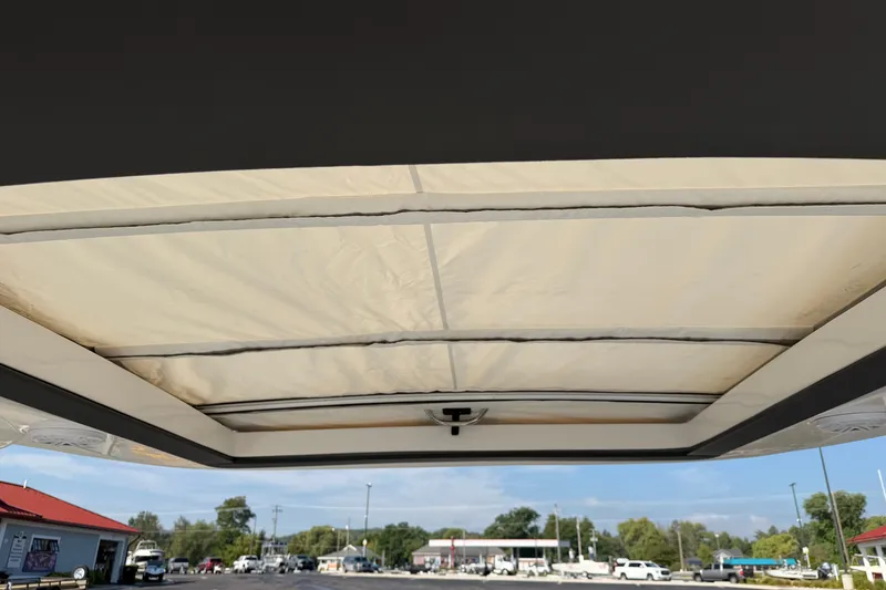 Slide: The Image of 2027 Regal 3300 boat canopy view with clear sky background. - 26