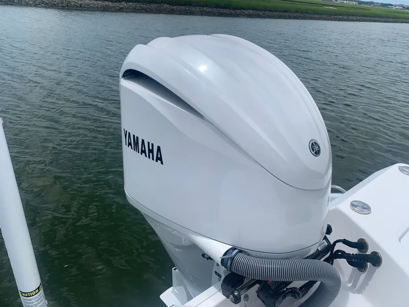 Slide: The Image of A Yamaha outboard motor on an Everglades 243 Center Console boat on calm water. - 36