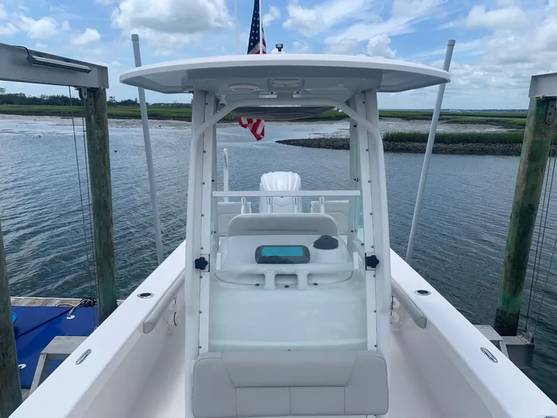 Slide: The Image of A 2023 Everglades 243 Center Console boat docked, overlooking the water. - 24