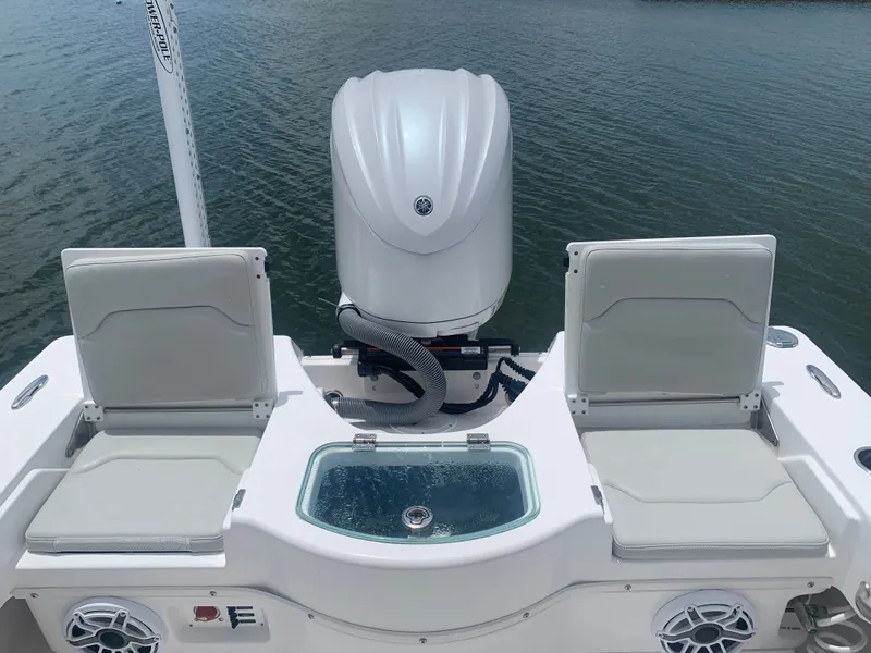 Slide: The Image of The image shows the stern of an Everglades 243 Center Console boat with two seats and an engine. - 9