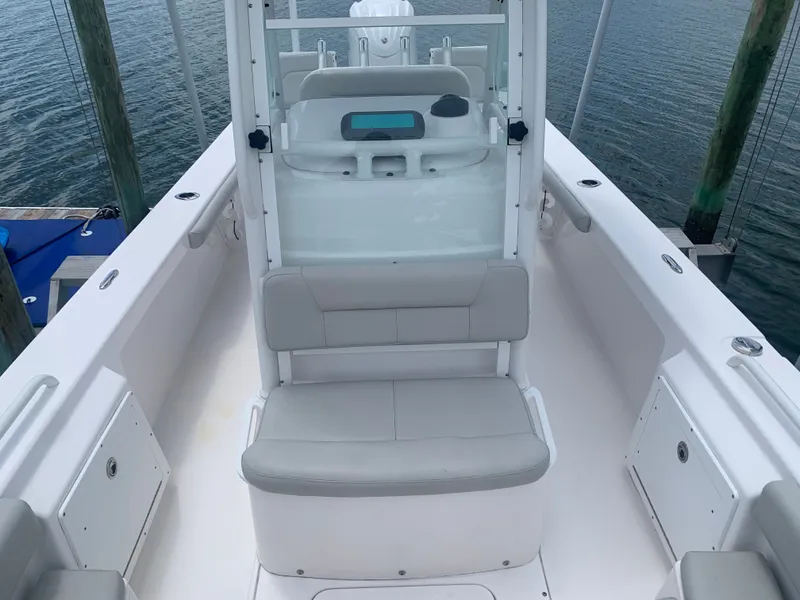 Slide: The Image of The image shows the cockpit of a 2023 Everglades 243 Center Console boat with gray seating. - 23
