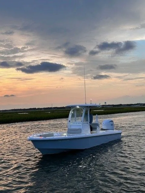 Slide: The Image of An Everglades 243 Center Console boat from 2023 on calm water at sunset. - 1