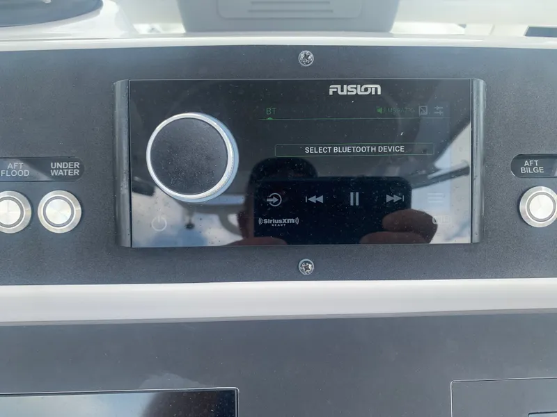 Slide: The Image of A Fusion audio system on a boat with Bluetooth options and controls. - 31