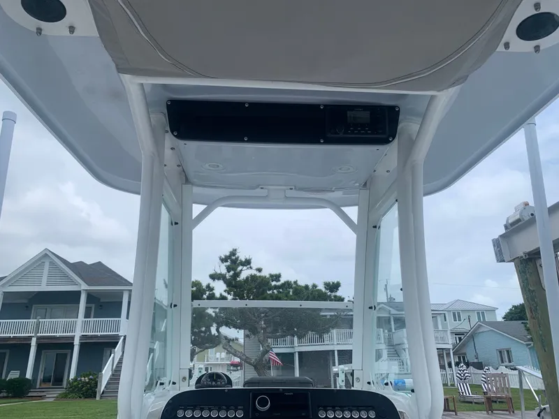 Slide: The Image of The image shows the helm of a 2023 Everglades 243 Center Console boat with houses in the background. - 40