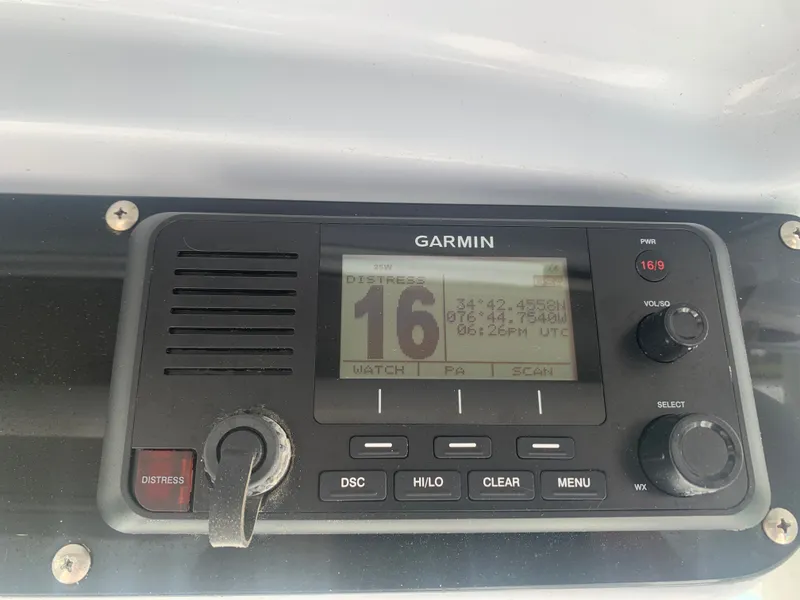 Slide: The Image of A Garmin radio with distress button and display showing coordinates and time. - 32