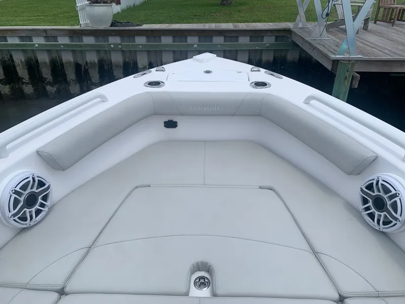 Slide: The Image of The image shows the bow of a 2023 Everglades 243 Center Console boat with cushioned seating. - 25
