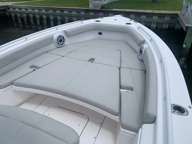 Slide: The Image of The image shows the bow of a 2023 Everglades 243 Center Console boat with gray cushions. - 21