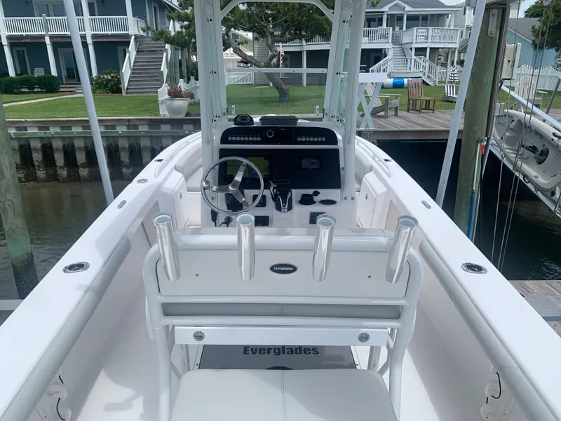 Slide: The Image of The image shows the cockpit of a 2023 Everglades 243 Center Console boat docked at a pier. - 14