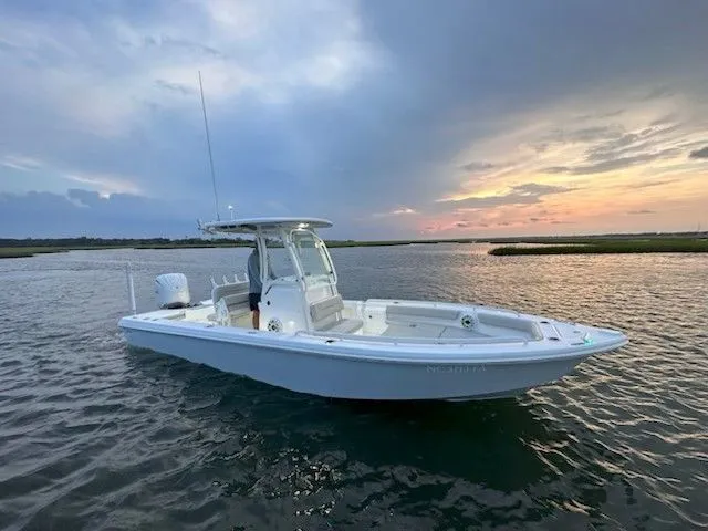 The Image of A 2023 Everglades 243 Center Console boat on calm water at sunset. - 0
