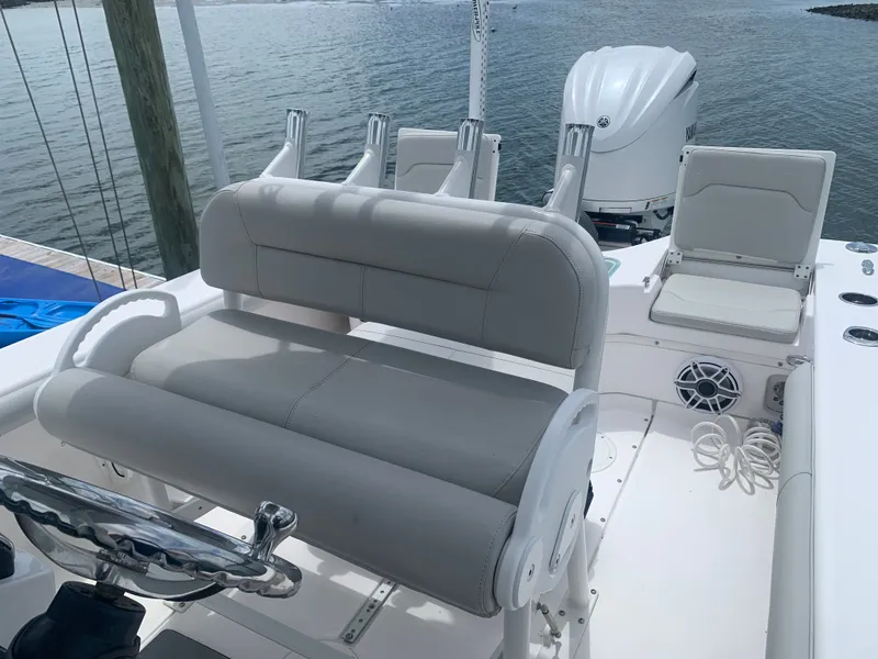 Slide: The Image of The image shows the cockpit of a 2023 Everglades 243 Center Console boat with gray upholstery. - 17