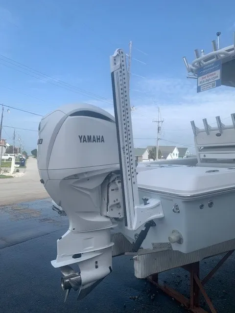 Slide: The Image of A 2023 Everglades 243 Center Console boat with a Yamaha outboard motor, on a dry dock. - 49