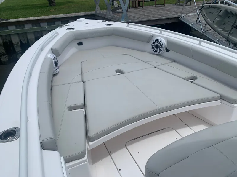 Slide: The Image of The image shows the bow area of a 2023 Everglades 243 Center Console boat with cushioned seating. - 22