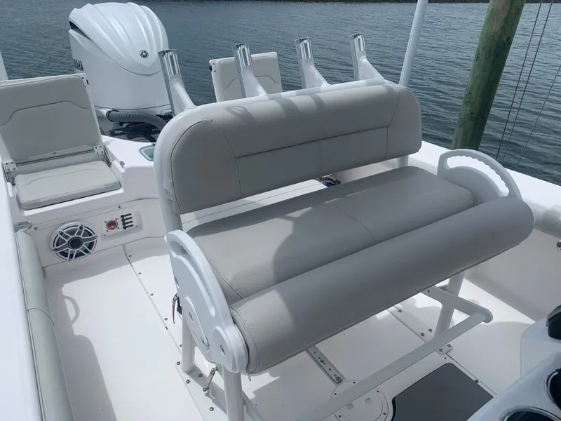 Slide: The Image of The image shows the cockpit of a 2023 Everglades 243 Center Console boat with gray upholstery. - 15