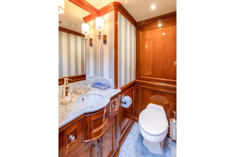 Slide: The Image of Luxurious yacht bathroom with marble sink, wooden cabinetry, and elegant lighting, Holland Jachtbouw Custom 2004. - 32