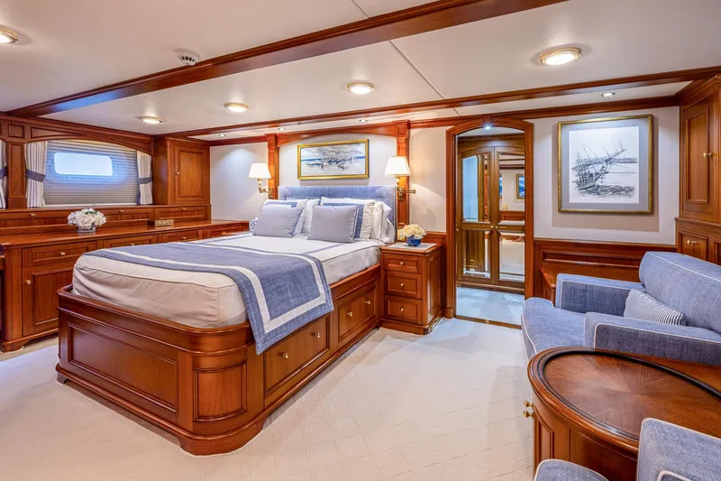 Slide: The Image of Luxurious yacht bedroom with elegant wood furnishings, blue accents, and cozy seating area, 2004 Holland Jachtbouw. - 44