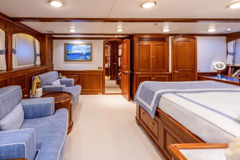 Slide: The Image of Luxurious yacht bedroom with wooden decor, blue accents, and elegant furnishings, Holland Jachtbouw Custom 2004. - 40