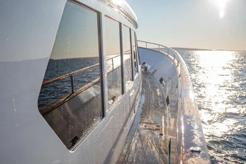 Slide: The Image of Side view of a 2004 Holland Jachtbouw Custom yacht on the ocean at sunset. - 14