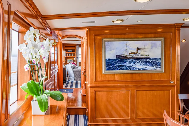 Slide: The Image of Luxurious yacht interior with wood paneling, artwork, and orchids, Holland Jachtbouw Custom 2004. - 54