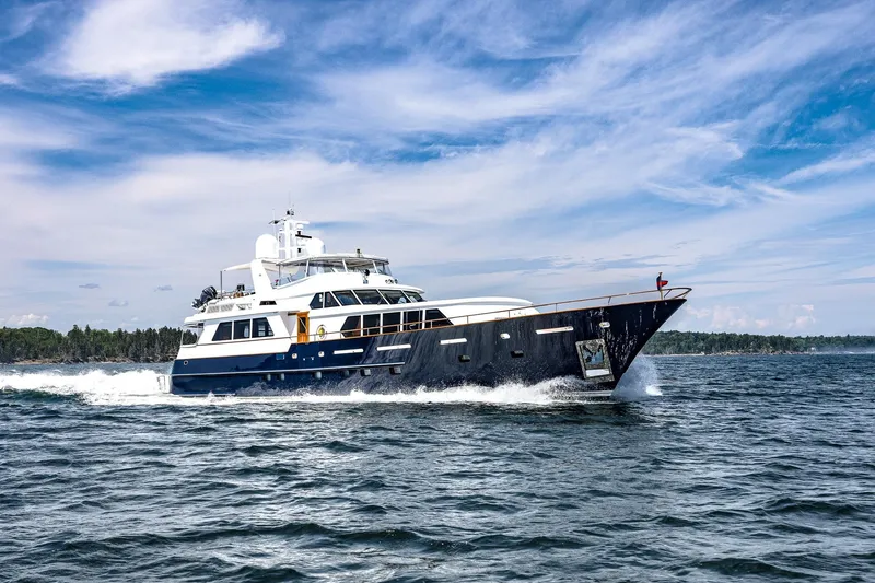 Slide: The Image of Luxurious 2004 Holland Jachtbouw Custom yacht cruising on open water under a clear sky. - 81