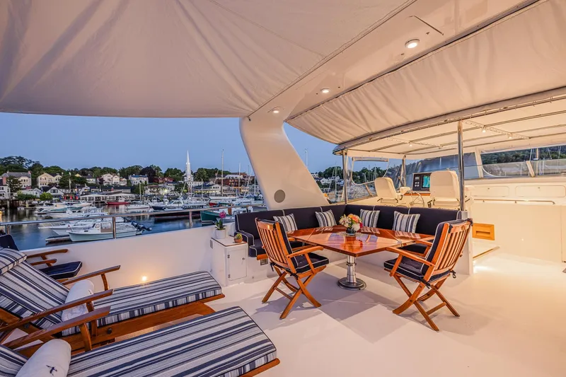 Slide: The Image of Luxurious 2004 Holland Jachtbouw Custom yacht deck with elegant seating and scenic marina view. - 29