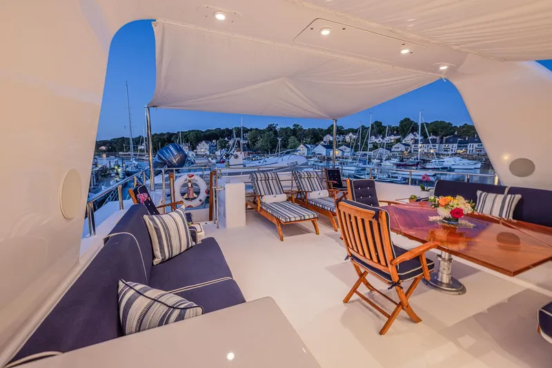 Slide: The Image of Luxurious 2004 Holland Jachtbouw Custom yacht deck with elegant seating and marina view. - 31