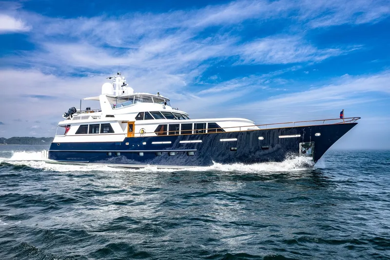 Slide: The Image of Luxurious 2004 Holland Jachtbouw Custom yacht cruising on open water under a clear blue sky. - 80