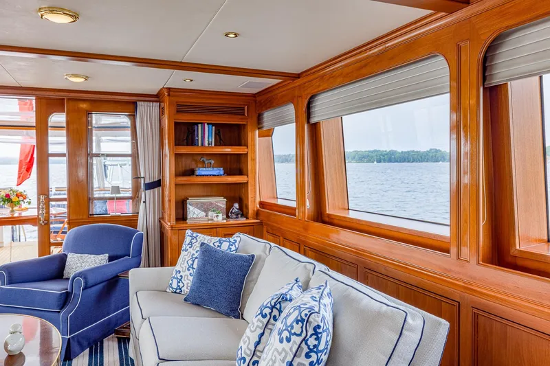 Slide: The Image of Luxurious yacht interior with elegant wood paneling, plush seating, and scenic water views. Holland Jachtbouw 2004. - 53