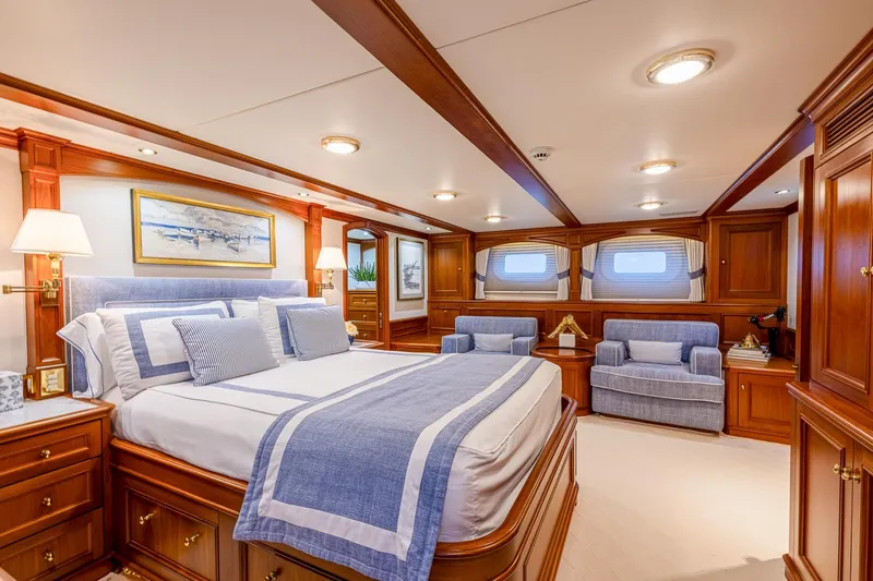 Slide: The Image of Luxurious yacht bedroom with elegant wood paneling, blue accents, and plush seating, Holland Jachtbouw 2004. - 43