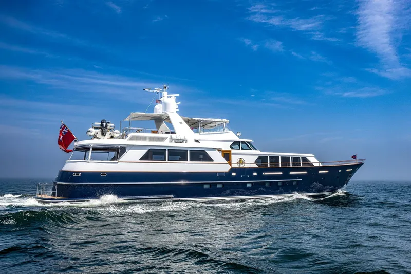 Slide: The Image of Luxurious 2004 Holland Jachtbouw Custom yacht cruising on open sea under clear blue sky. - 79
