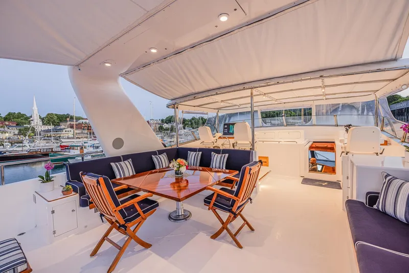 Slide: The Image of Luxurious 2004 Holland Jachtbouw Custom yacht deck with elegant seating and dining area. - 26