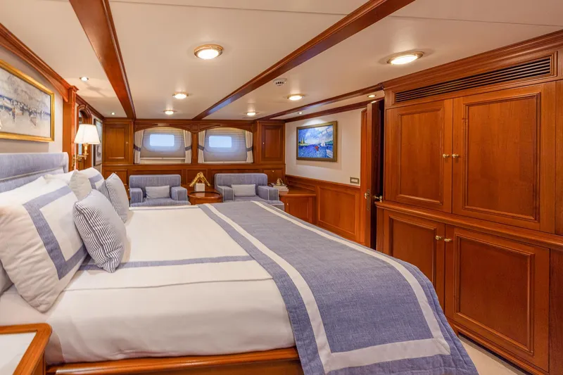 Slide: The Image of Luxurious yacht bedroom with elegant wood paneling, plush bedding, and cozy seating, Holland Jachtbouw 2004. - 42