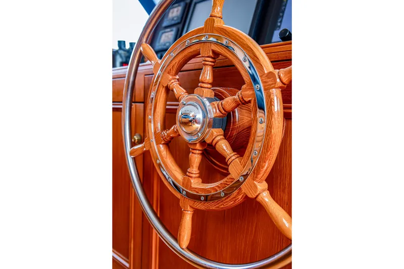 Slide: The Image of Wooden steering wheel of a 2004 Holland Jachtbouw Custom yacht, showcasing craftsmanship. - 56
