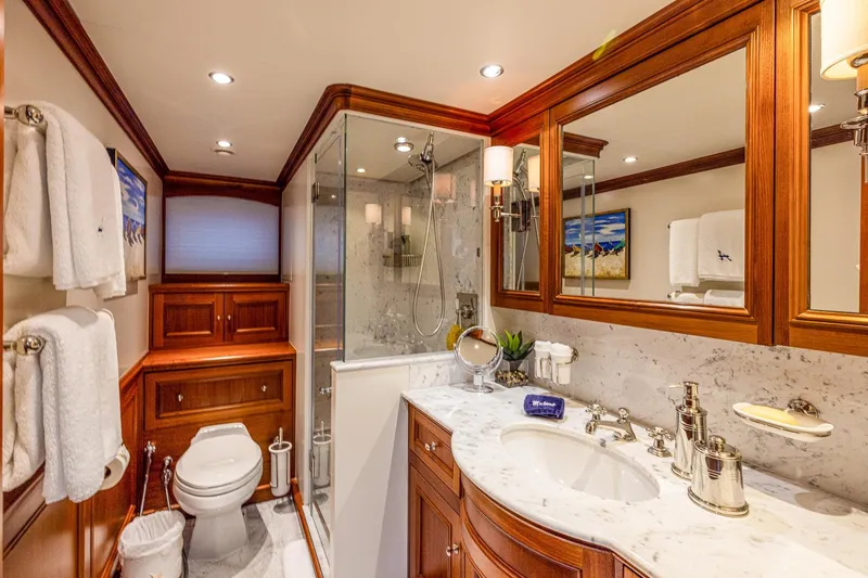 Slide: The Image of Luxurious yacht bathroom with marble countertop, wooden cabinetry, and glass shower, Holland Jachtbouw 2004. - 41