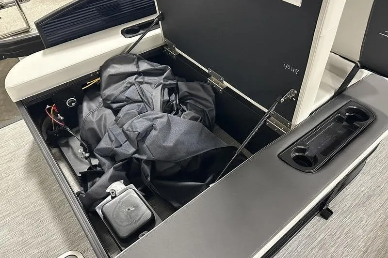 Slide: The Image of Open storage compartment in 2026 Bennington S Swingback 22 SSB boat, showing interior details. - 12