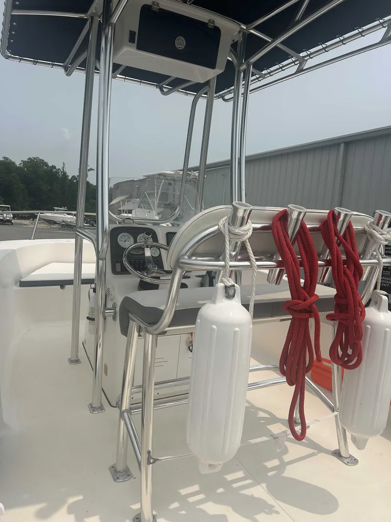 Slide: The Image of The image shows the cockpit of a 2015 Tidewater 180 CC Adventurer with a helm console and seating. - 2