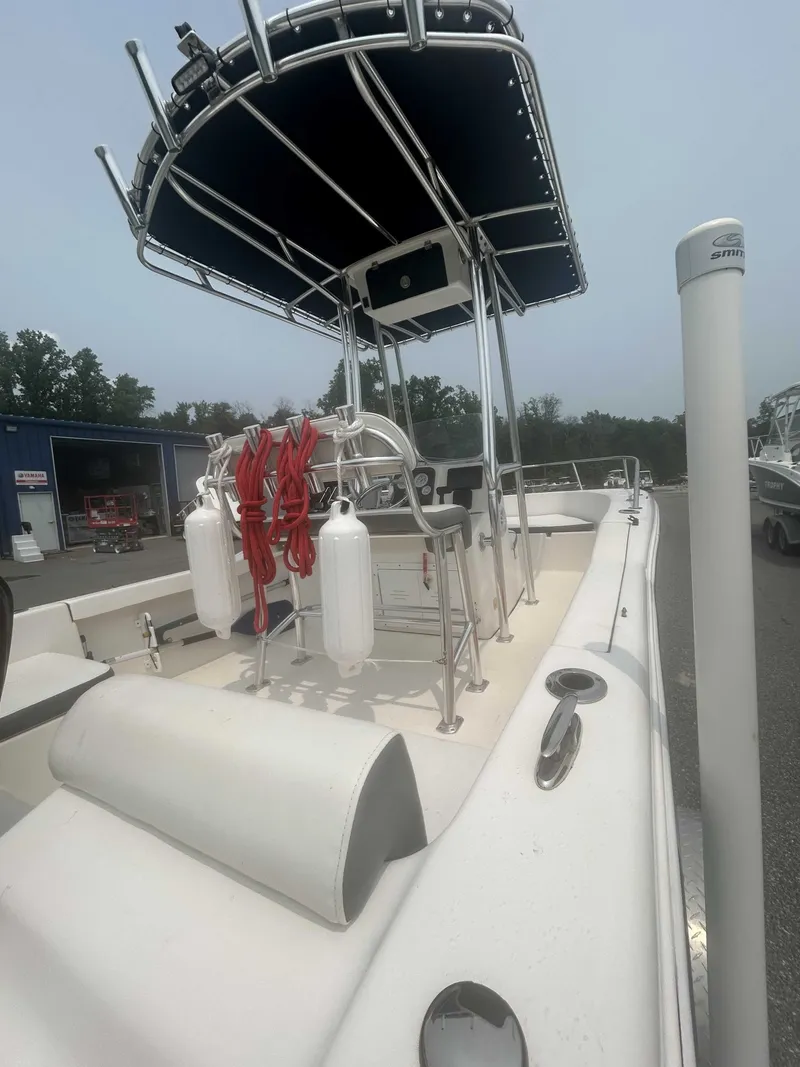 Slide: The Image of A white boat with a black sunshade and safety equipment on board, parked in a lot. - 3