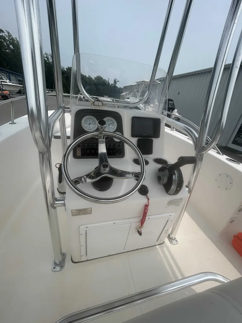 Slide: The Image of The image shows the helm of a 2015 Tidewater 180 CC Adventurer with a steering wheel and instruments. - 6