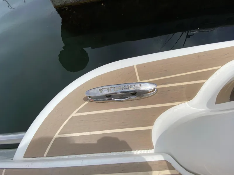 Slide: The Image of 2017 Formula 350 Sun Sport boat deck with logo near water. - 37