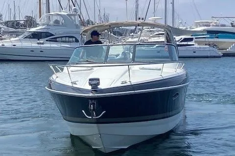 Slide: The Image of 2017 Formula 350 Sun Sport boat cruising in a marina with yachts in the background. - 2