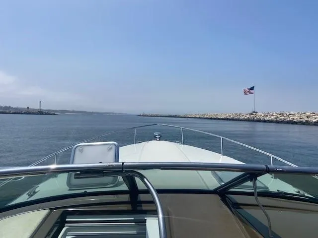 Slide: The Image of View from a 2017 Formula 350 Sun Sport boat cruising in a harbor with an American flag. - 7