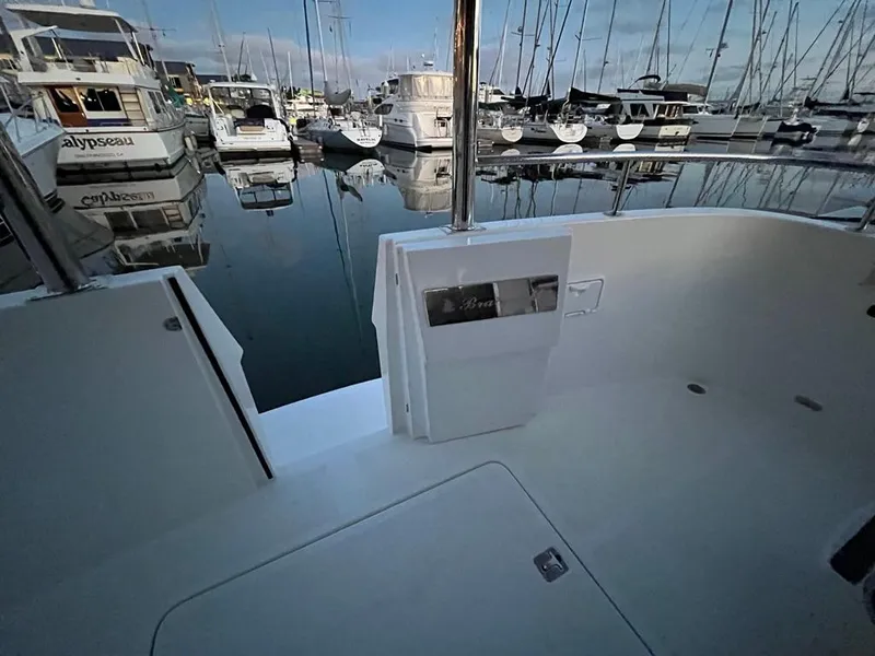 Slide: The Image of The image shows the deck of a boat in a marina, surrounded by other boats. - 53