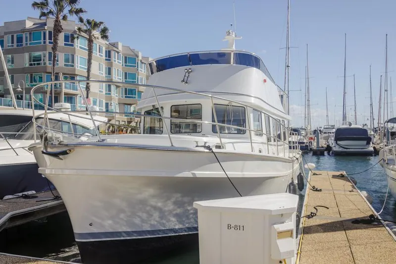 Slide: The Image of 2025 Bracewell 41 yacht docked at a marina with modern buildings in the background. - 4