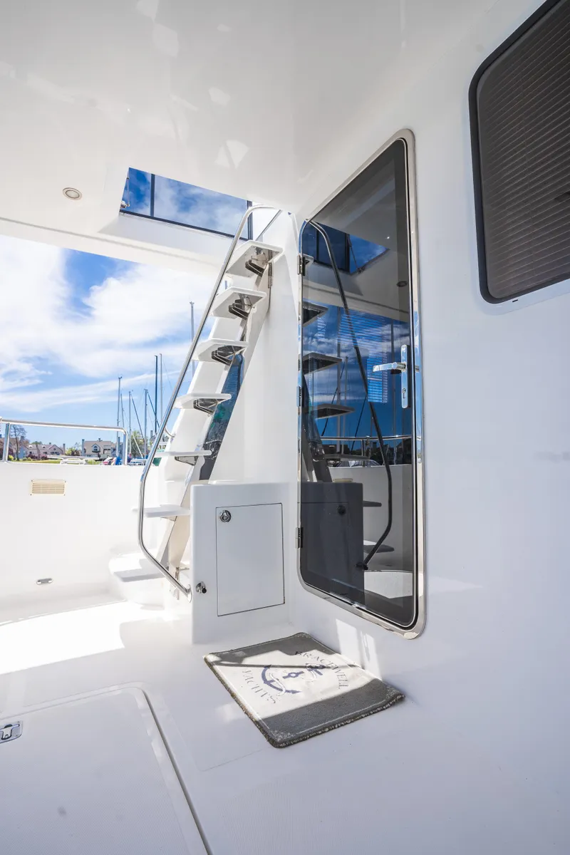 Slide: The Image of Modern Bracewell 41 yacht interior with sleek stairs and glass door, 2025 model. - 7