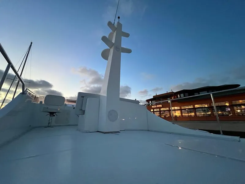 Slide: The Image of The image shows the deck of a Bracewell 41 yacht at sunset in a harbor. - 59