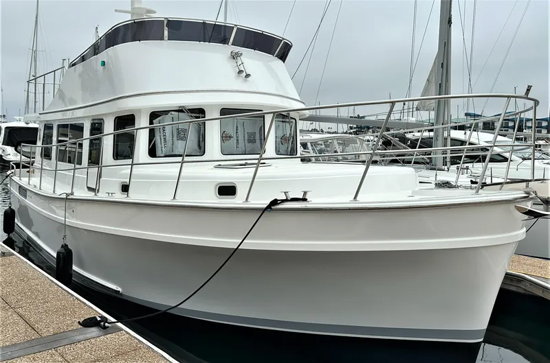 Slide: The Image of 2025 Bracewell 41 yacht docked at marina, featuring sleek white design and spacious deck. - 1